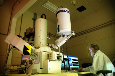 'My principal research aim is to look cool in a lab coat while operating a huge microscope.' [Photo: Idaho National Laboratory]