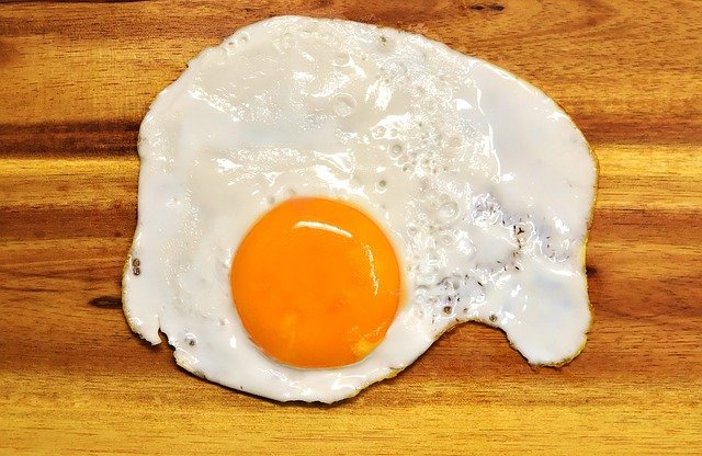 A fried egg, yolk on show.